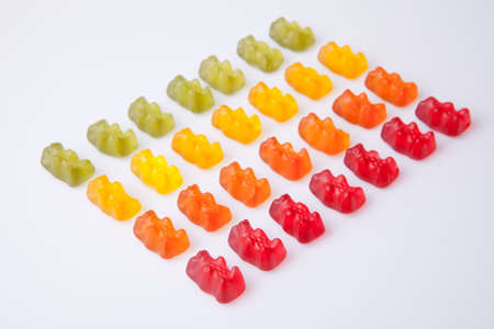 Rows of colorful gummy bears isolated over white background