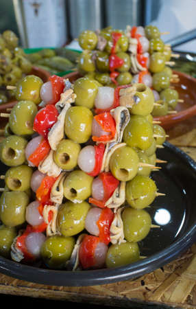 Skewered appetizers or spanish banderillas. Delicious brochettes filled with tuna