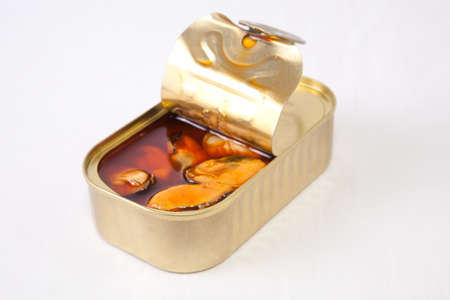 Mussels in a tin with a brown escabeche sauce of vinegar, oil and garlic. isolated on white