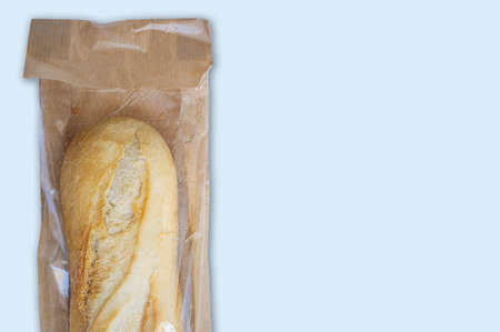 Baguette bread in plastic lined paper bag with clear window. isolated over whiteの写真素材