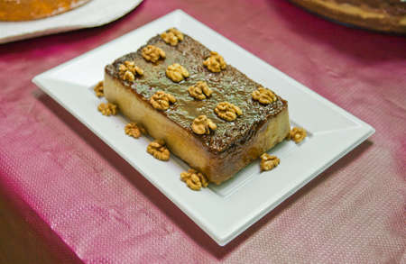 Beautifully presented Walnut cake on a white cake plate