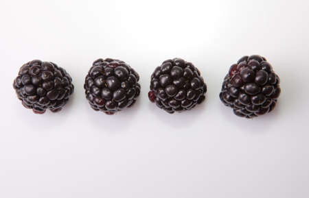 Fresh ripe blackberries online. Isolated over white background. shot from above