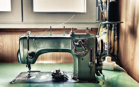Old green electrical sewing machine at daylightの写真素材