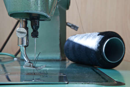 Old green electrical sewing machine at daylight
