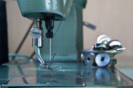 Old green electrical sewing machine at daylight