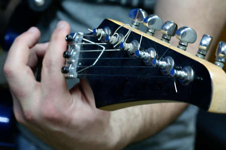 Electric guitar close up with hand playing it