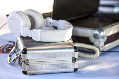 Dj table for wedding with headphones, suitcases and laptop. selective focusの写真素材