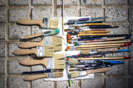 Artist brushes versus decorator brushes. Thicker ones used for filling in, thinner ones are used for detailsの写真素材