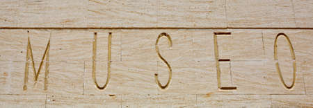 Museum sign in Spanish. Bass relief over limestone