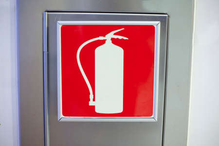 One wall mounted aluminum box for fire extinguisher with red icon extinguisherの写真素材
