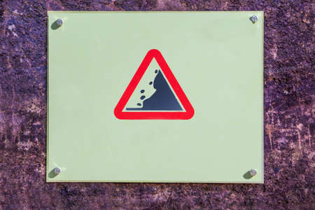 Landslide Caution falling rocks sign attached to the rock, Malaga, Spainの写真素材