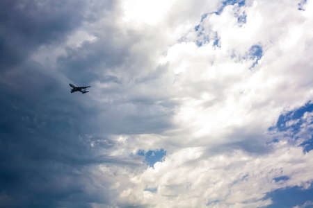Passenger plane approaching against a stormy sky