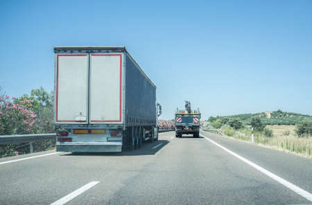 Truck overtaking slowly another truck. View from inside the carの写真素材