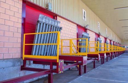 Truck loading docks at commercial building. Overhead door, dock leveler, and dock seals