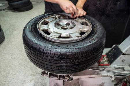 Car repairman hands checking the tire pressure. motion blurred shotの写真素材
