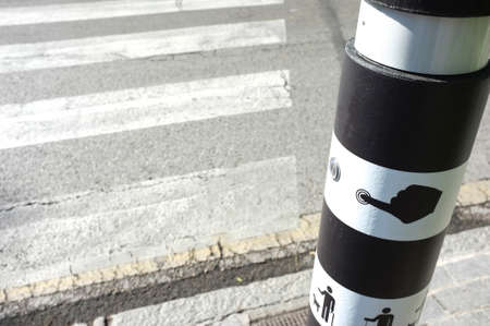 Pedestrian crossing traffic pole for blind people. Emerging lighting on ground and auditory system