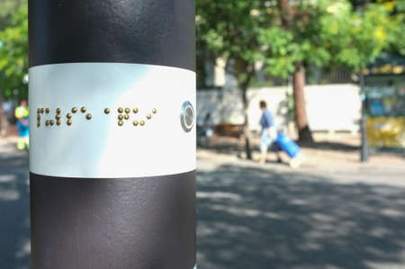 Pedestrian crossing traffic pole for blind people. Emerging lighting on ground and auditory systemの写真素材