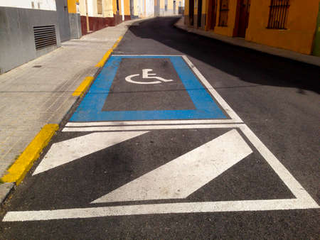 Disabled parking sign place on old downtown steetの写真素材