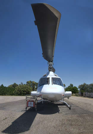 Helicopter close up on ground, shot under its propeller