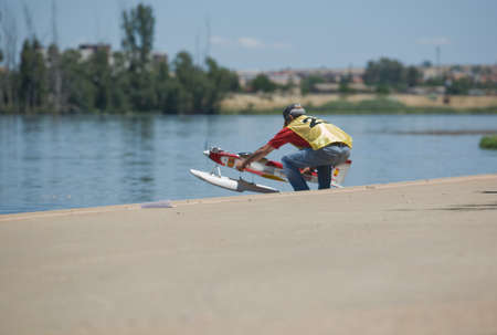 BADAJOZ, SPAIN - JUNE 8: unidentified parcipant put a RC hydroplane over the water of Guadiana river, during an exhibition show on June 8, 2014. Badajoz, Spainのeditorial素材