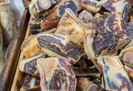 Iberian cured hambone displayed at street market stall. selective focus