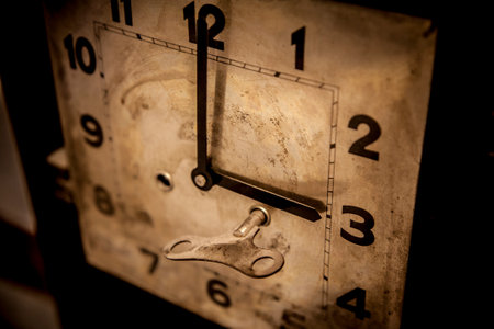 Antique brass winder clock. Key or crank into a winding pointの写真素材