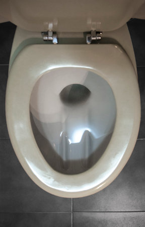 Old regular toilet with excessive use of water. Low-efficiency toiletsの写真素材