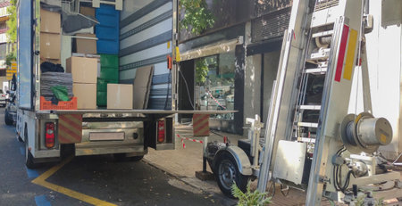Semi-trailer moving truck and ladder lift at downtown street. Urban area moves concept