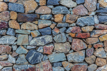 Natural colorful rust quartzite wall. irregular shape stonesの写真素材