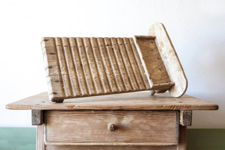 Old wooden washboard. Displayed over wooden tableの写真素材