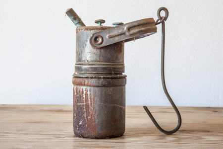 Old rusty carbide lamp. Acetylene gas lamp over wooden surface