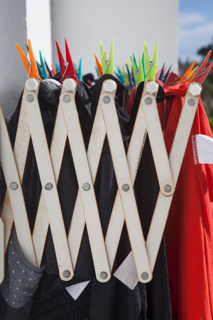 Full-loaded heavy Duty Wall-Mounted Drying Rack at apartment block. Selective focus on pegs