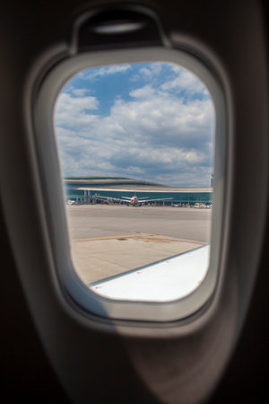 Boarding terminal seen from aircarft window. blue cloudy skyの写真素材