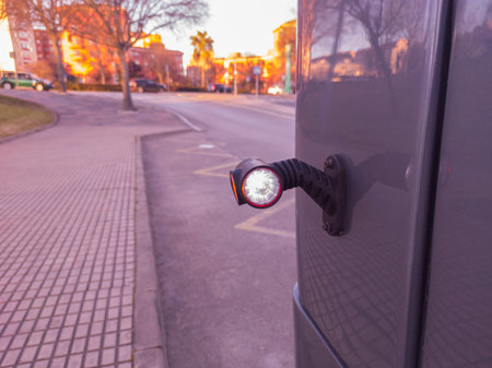 Rear side marker light attached on bus. Urban sunset backgroundの写真素材