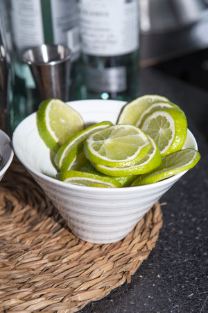 Bowl full of lime slices ready for serving cocktails. selective focusの写真素材