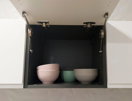 Top kitchen cupboard showing dishware. Handleless cupboards conceptの写真素材