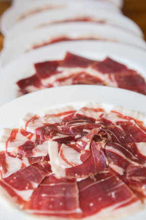 Acorn-fed iberian ham on plates. Selective focusの写真素材