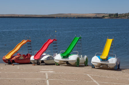 Orellana, Spain - August 4th, 2023: Costa Dulce de Orellana, unique inland beach in Spain awarded with the Blue Flag, Badajoz, Spain. Pedal boats for rentのeditorial素材
