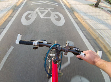 Cyclist riding and priority lane for bikes and electric kick scooters. POV shotの写真素材