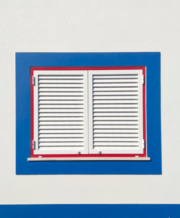 Window painted with vivid colors at Vila Nova de Milfontes house. Little picturesque town on the Alentejo coast, Portugalの写真素材