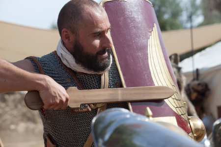Merida, Spain - Oct 9th, 2021: Roman soldier wielding a wooden training sword. Emerita Ludica...