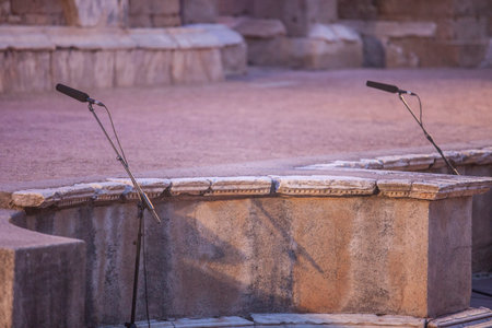 Merida, Spain - Jun 3rd, 2023: Theater stage microphones during performance. Emerita Ludica Festival 2023.のeditorial素材