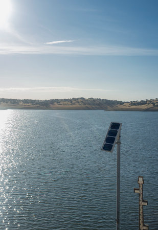 Scale for water level measurement of reservoir. Measuring instrument powered by a solar panel