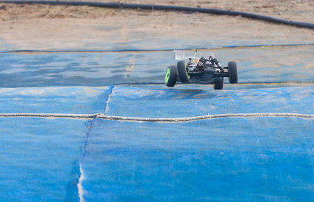 Merida, Spain - Jan 28th, 2024: Extremadura 1/8tt gas Championship RC Car. Jumping over blue turfのeditorial素材