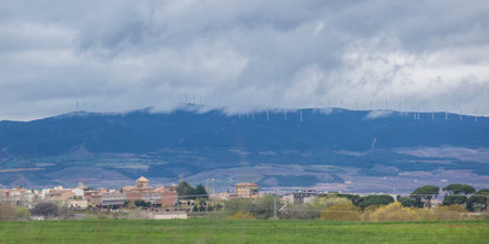 Wind turbines on the top of the hills. Little town in the foreground