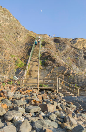 Nossa Senhora beach, Zambujeira do Mar, Portugal. Visitor man ascending the long and steep stairsの写真素材