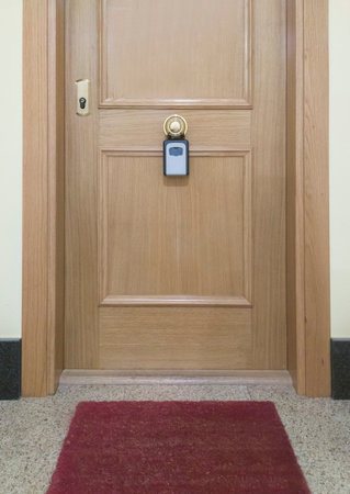 Tourist flat door with hanging key box. Tourist flats conceptの写真素材