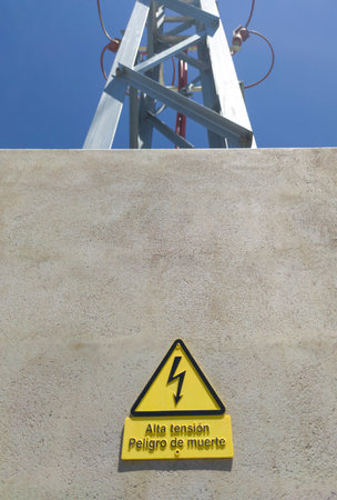 Danger of death electricity warning sign. It is attached to protection concrete wall