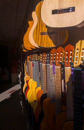 Spanish guitars shop. Sun rays partially illuminating the guitarsの写真素材