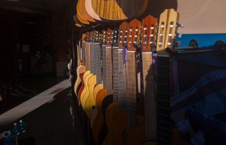 Spanish guitars shop. Sun rays partially illuminating the guitarsの写真素材
